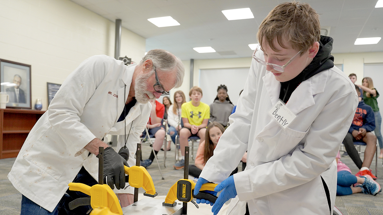 John Cranston (left) teaches a student at J.F. Drake Middle School in Auburn during a Bird Inc. class activity in 2023. 
