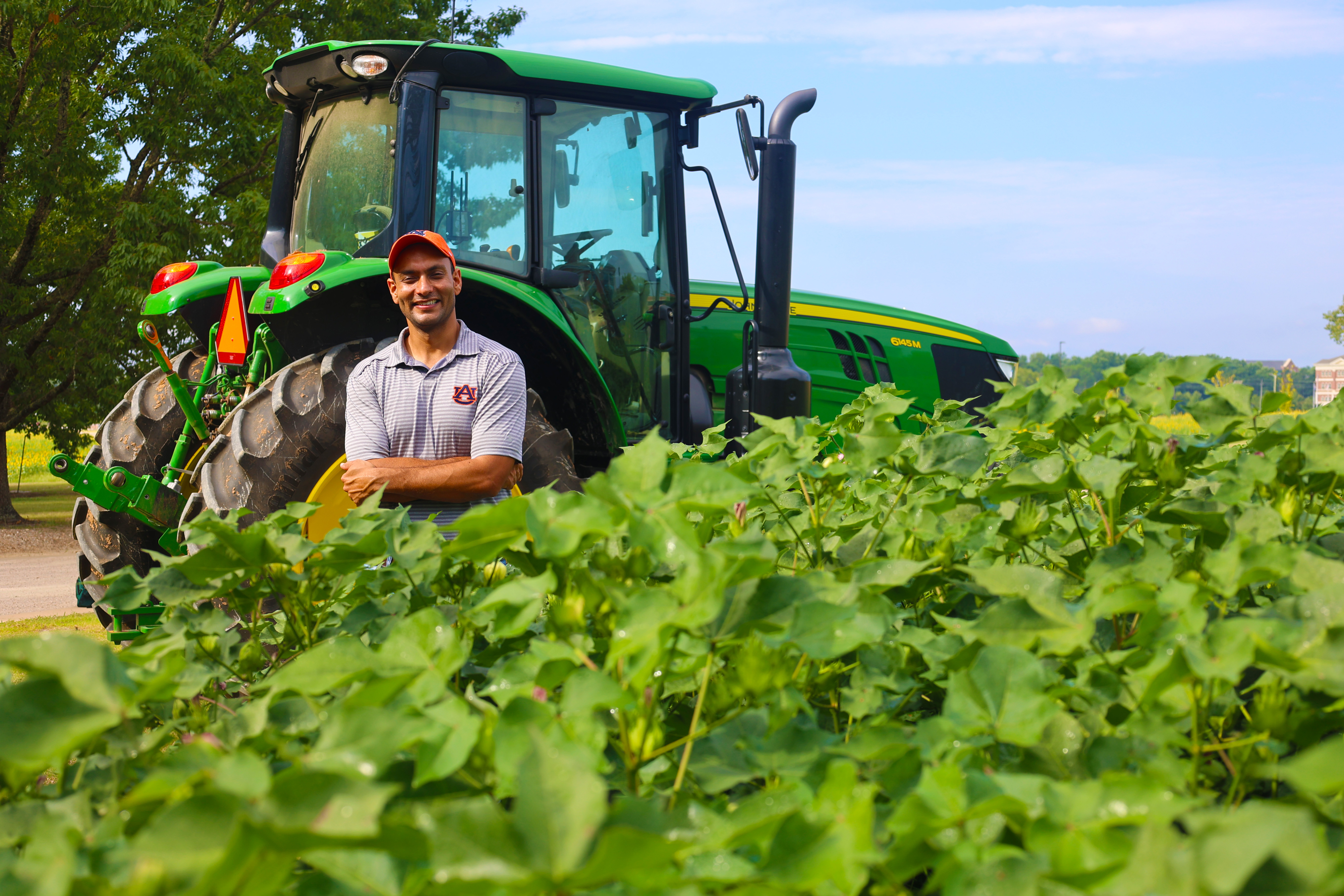 Dr. Simerjeet Virk in front of a tractor