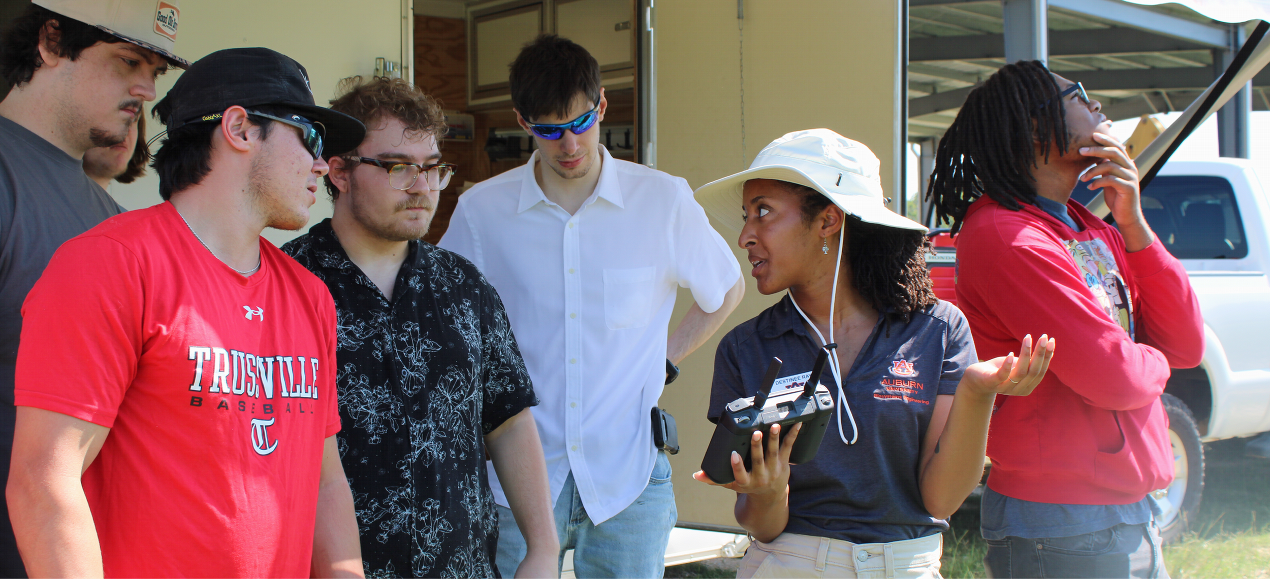 Students look at a drone controller just a demonstration flight