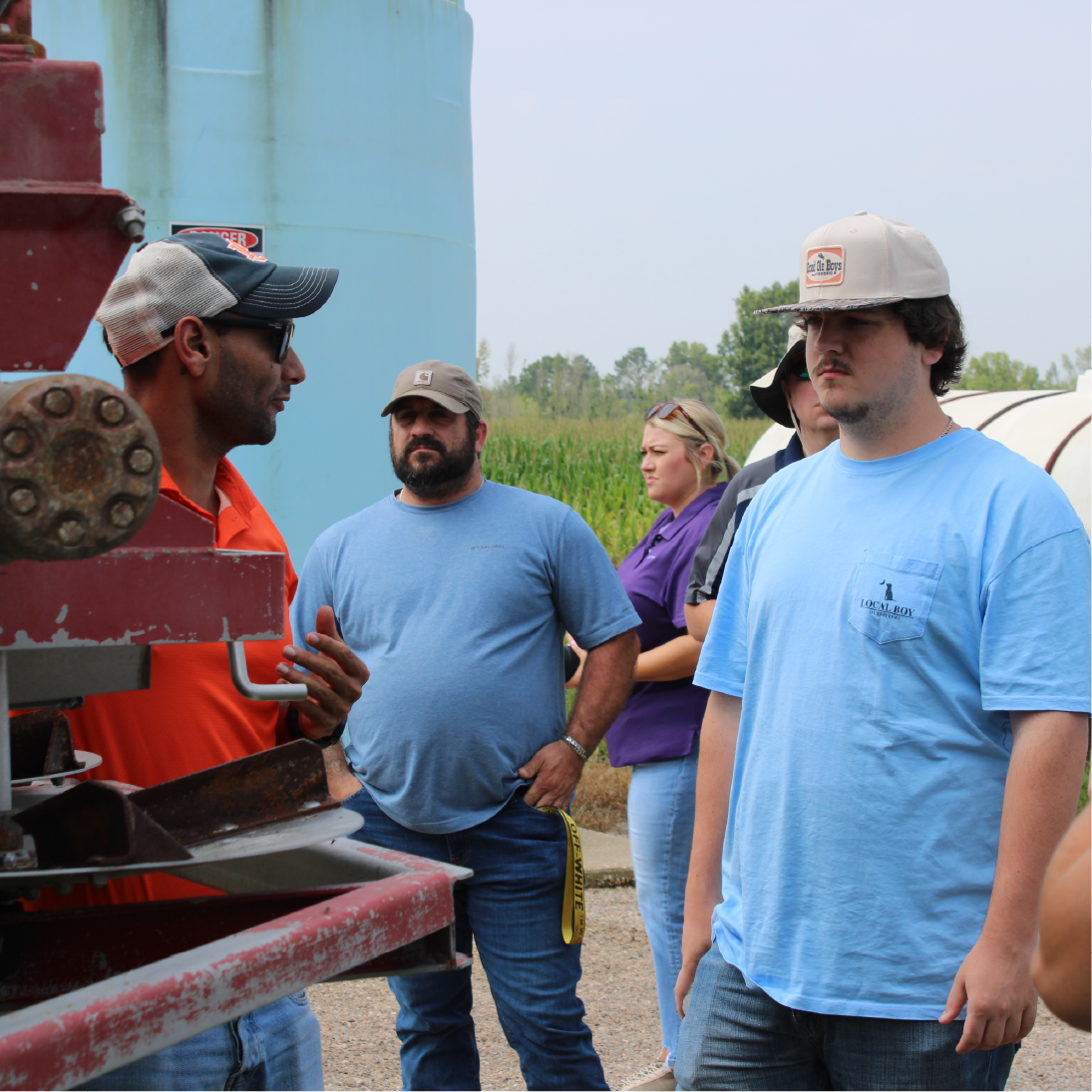 students listening to a talk about a harvester 