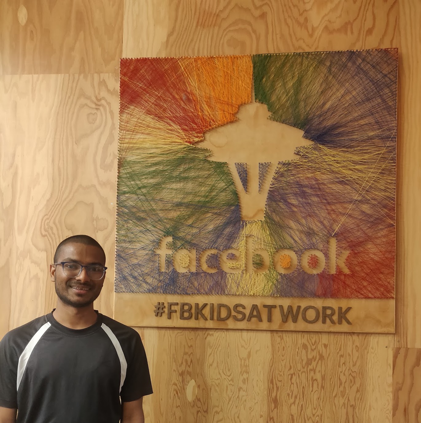 intern in front of logo