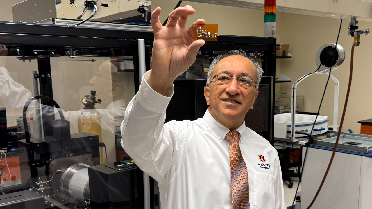 Pradeep Lall, director of the Auburn University Electronics Packaging Research Institute, displays additive electronics for automotive applications.