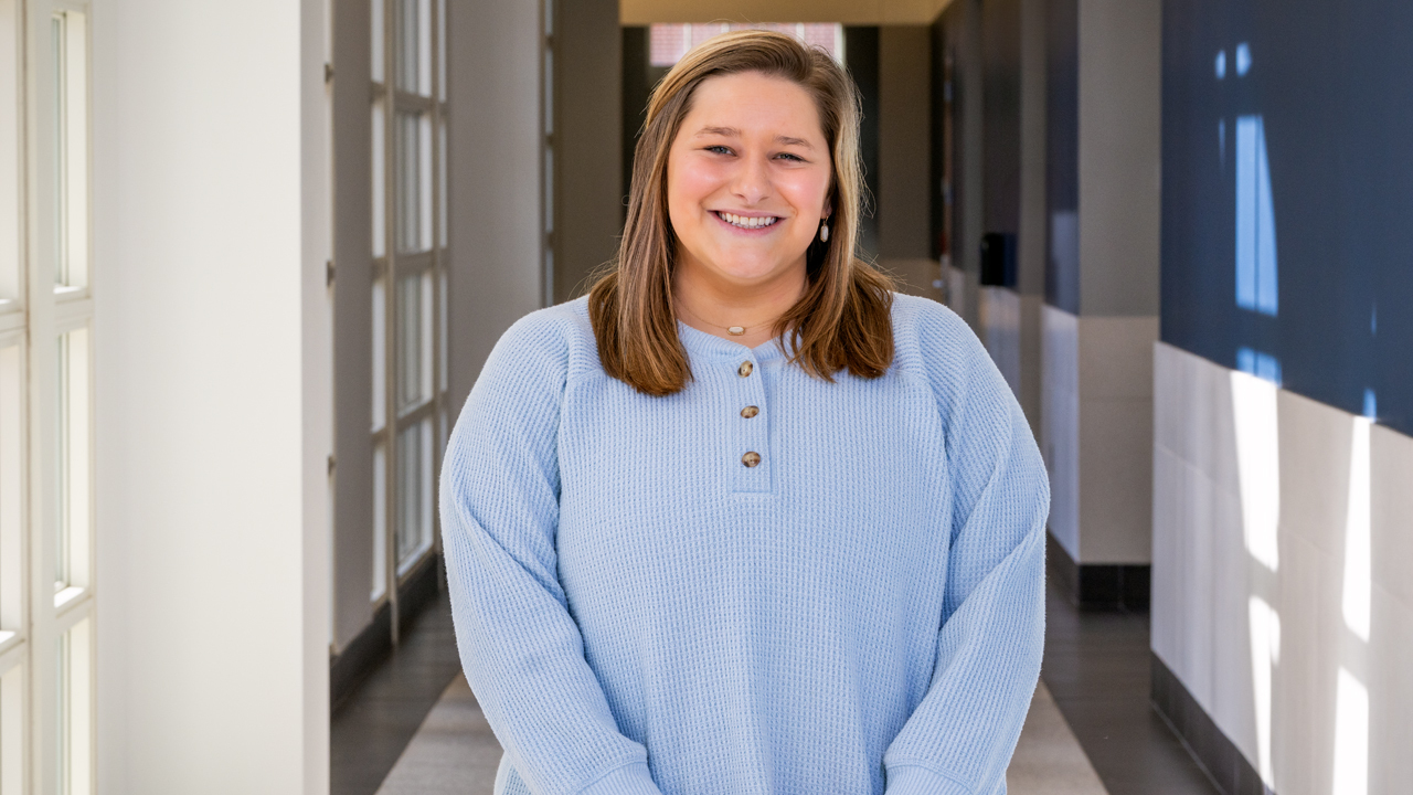 woman speaks to group of students