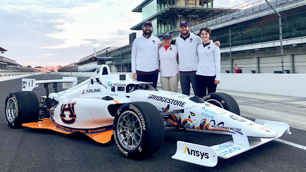 Autonomous Tiger Racing team members pose with their autonomous vehicle at the Indianapolis Motor Speedway.