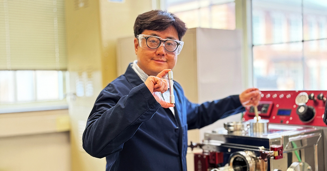 Chanho Lee, assistant professor in mechanical engineering, holds a newly designed and fabricated refractory multi-principal element alloy sample prepared for a mechanical property test.
