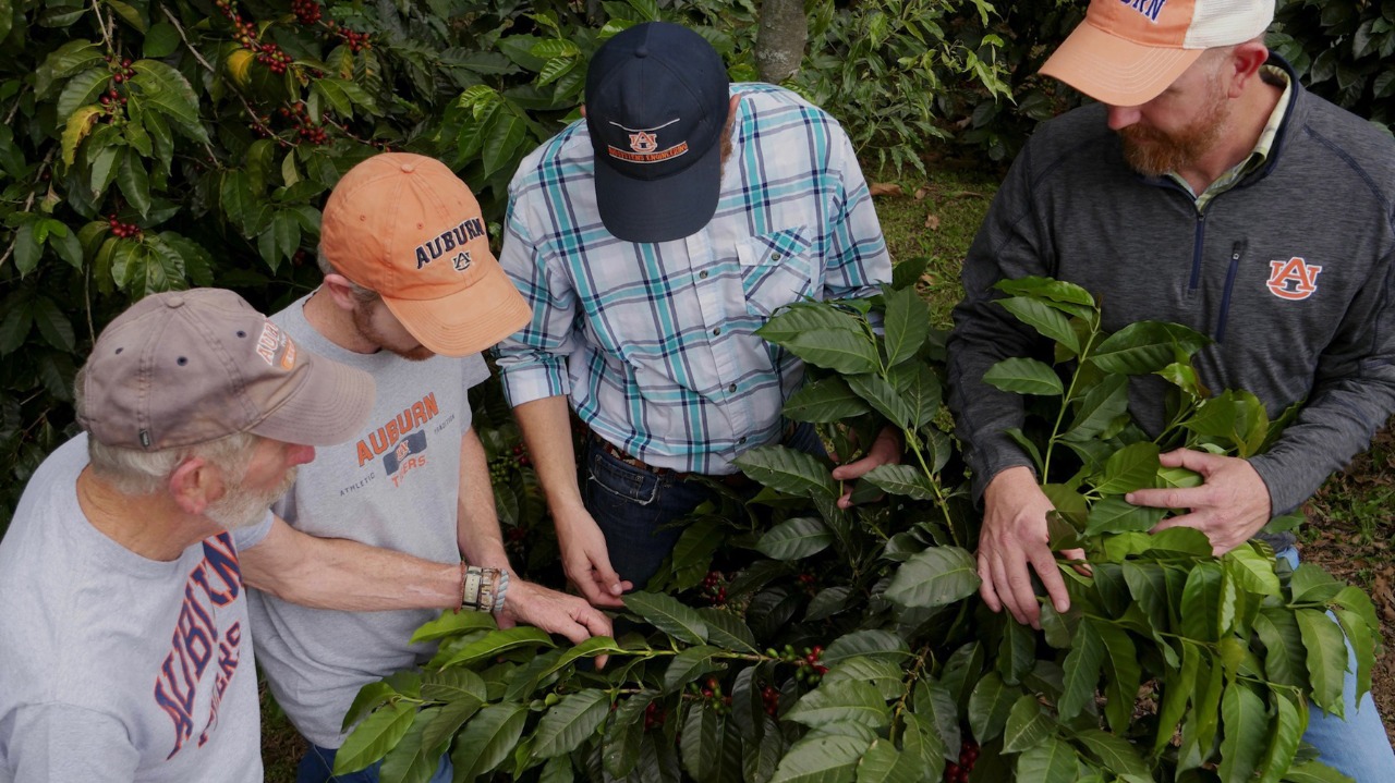 two men pose for photo outside