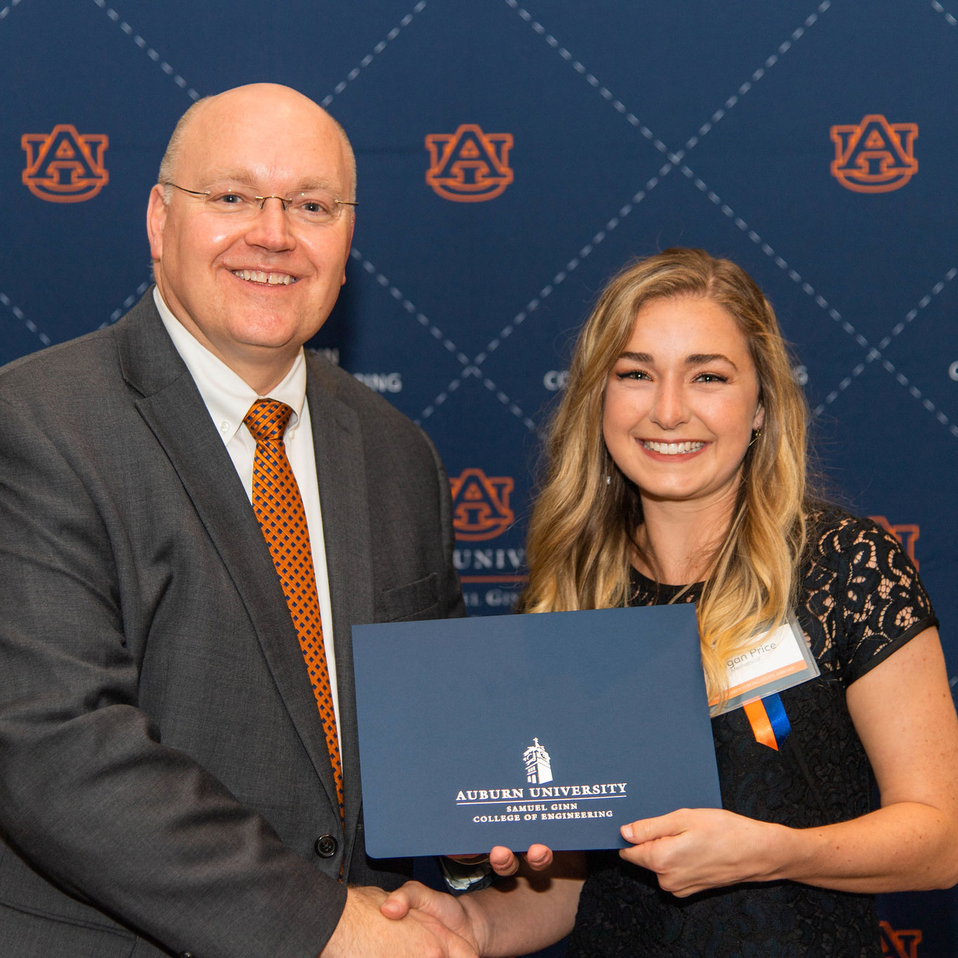 Morgan Price, a graduate student in mechanical engineering, received a 100+ Women Strong Study Abroad Award. She is pictured with Dean Christopher B. Roberts.
