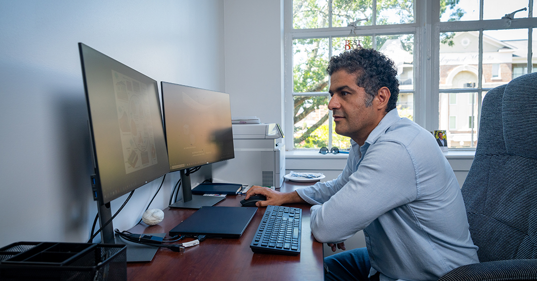 Ali Khosravi works at a computer in his Auburn University office.