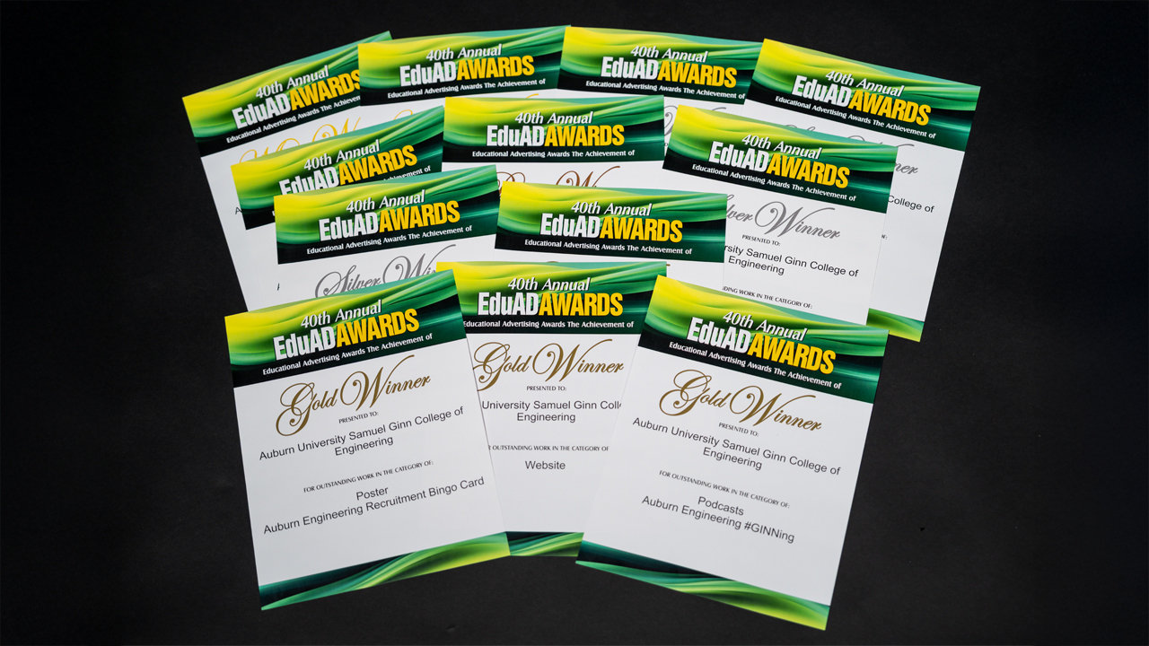 Woman holds awards with white background