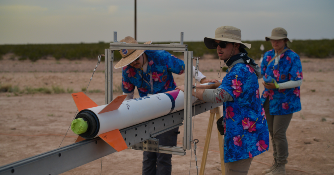 AURA team members work on their rocket at the IREC in Texas.