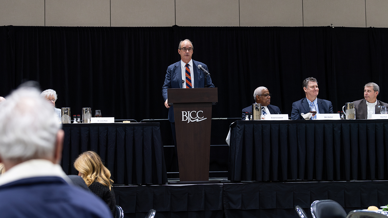 man speaks at conference