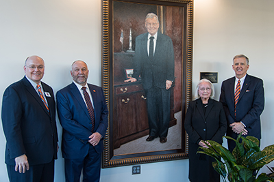 Christopher B. Roberts, dean of engineering; Steven Leath, Auburn University president; Dorothy Davidson, CEO and president of Davidson Technologies; and Michael DeMaioribus, Auburn University Board of Trustees president pro tempore with a portrait of Julian Davidson.