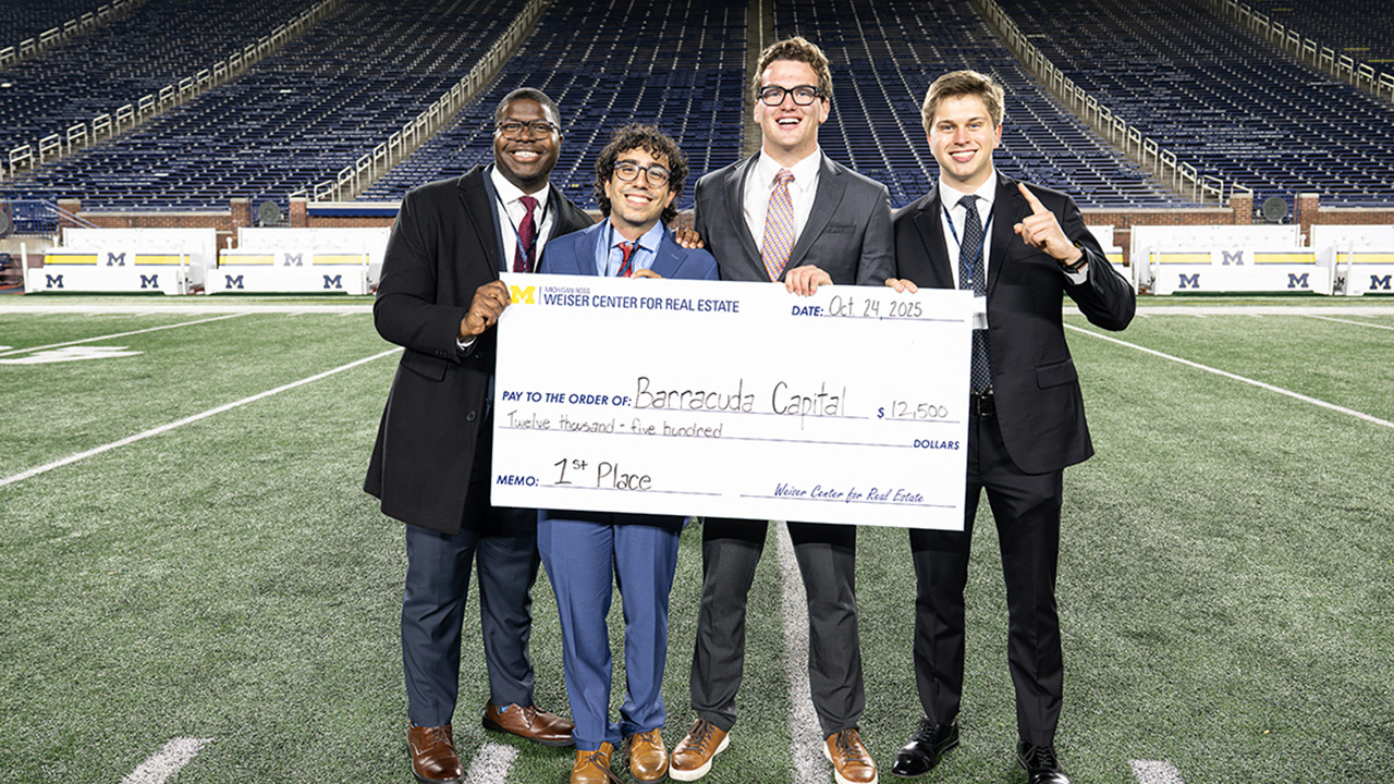 FMA team members (left to right) Parker Duncan, Matthew Hajazin, Grady Marshall and Joseph McElroy (computer science) celebrate their victory at the 2025 REIT case competition, which took place in the suites of Michigan Stadium.ncluded post-event tours and activities on the field.