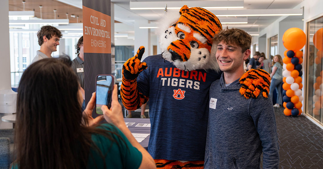 A prospective student poses with Aubie during Future Engineer Fest 2026.