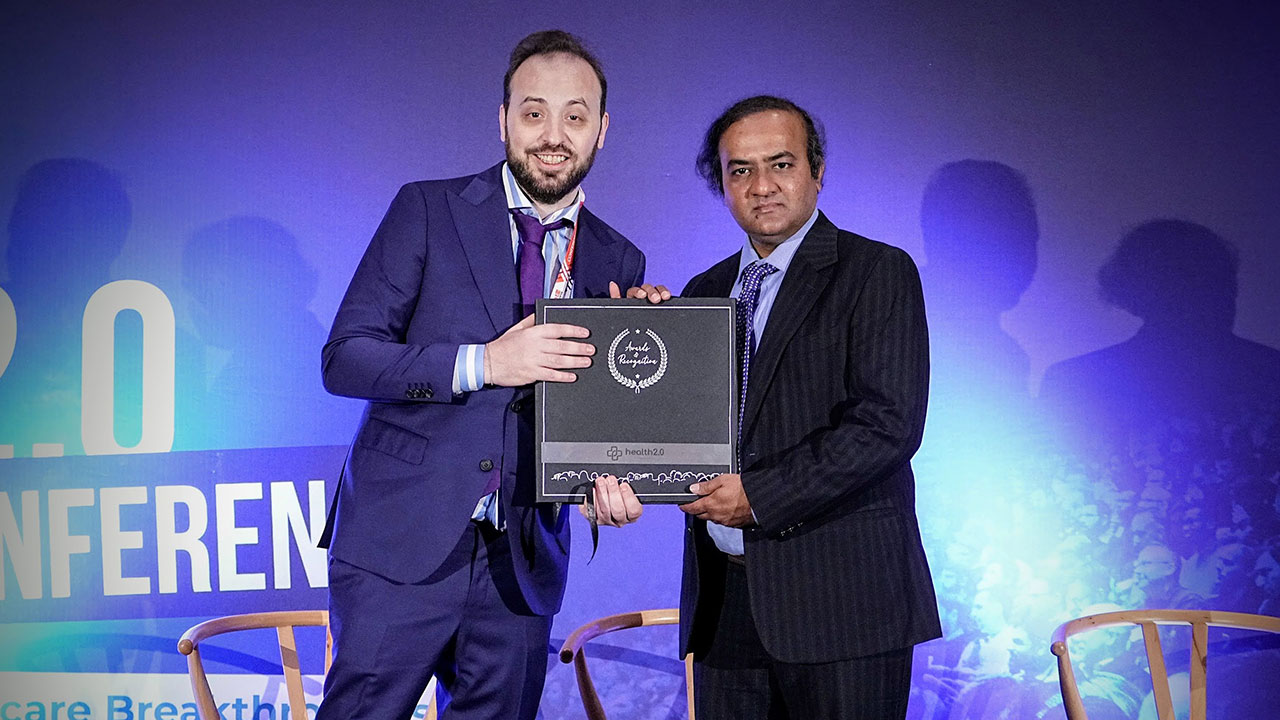 Gopikrishna Deshpande, right, professor in the Department of Electrical and Computer Engineering, accepts the Outstanding Leadership Award from Vincent W. Allen, founder and managing director of VAAV Industries.