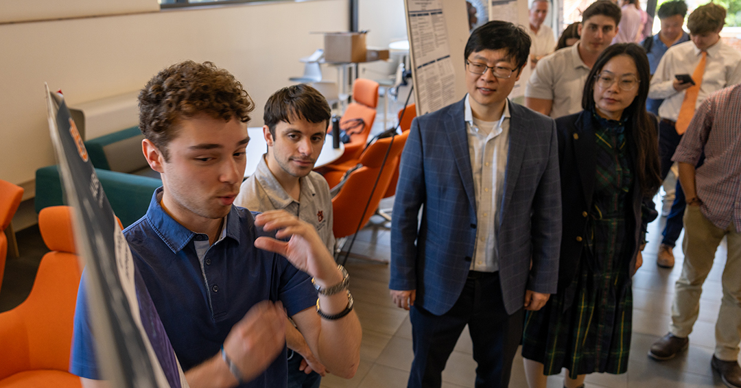 Jason Gentry, a senior in electrical engineering, presents before peers and faculty, including Applied Statistics and Machine Learning course co-directors Yin Sun, the Godbold Associate Professor in the Department of Electrical and Computer Engineering, and Rui Chen, the Research Extension Assistant Professor at Tuskegee University. Also observing are students Carson Easterling and Sam Chamoun. 