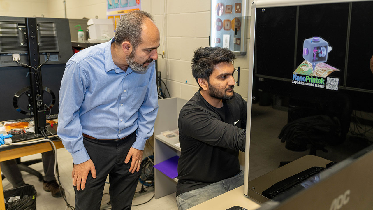 Masoud Mahjouri-Samani, associate professor in electrical and computer engineering, works with graduate student Aarsh Patel.
