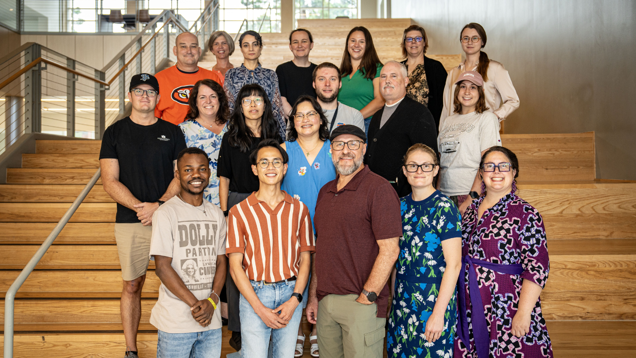 Faculty, staff, and graduate students gather on the steps of the Academic Classroom and Laboratory Complex during a peer teaching and learning event hosted at Auburn University.