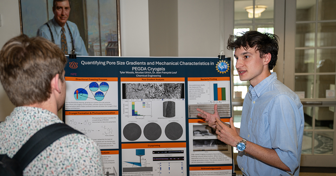 Tyler Woods, a junior in chemical engineering, explains his team's research project, "Quantifying Pore Size Gradients and Mechanical Characteristics in PEGDA Cryogels," during a poster presentation on Wednesday, July 22.