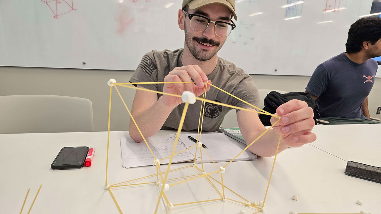 Students in COMP 2240 build 3D graph models using spaghetti and marshmallows.