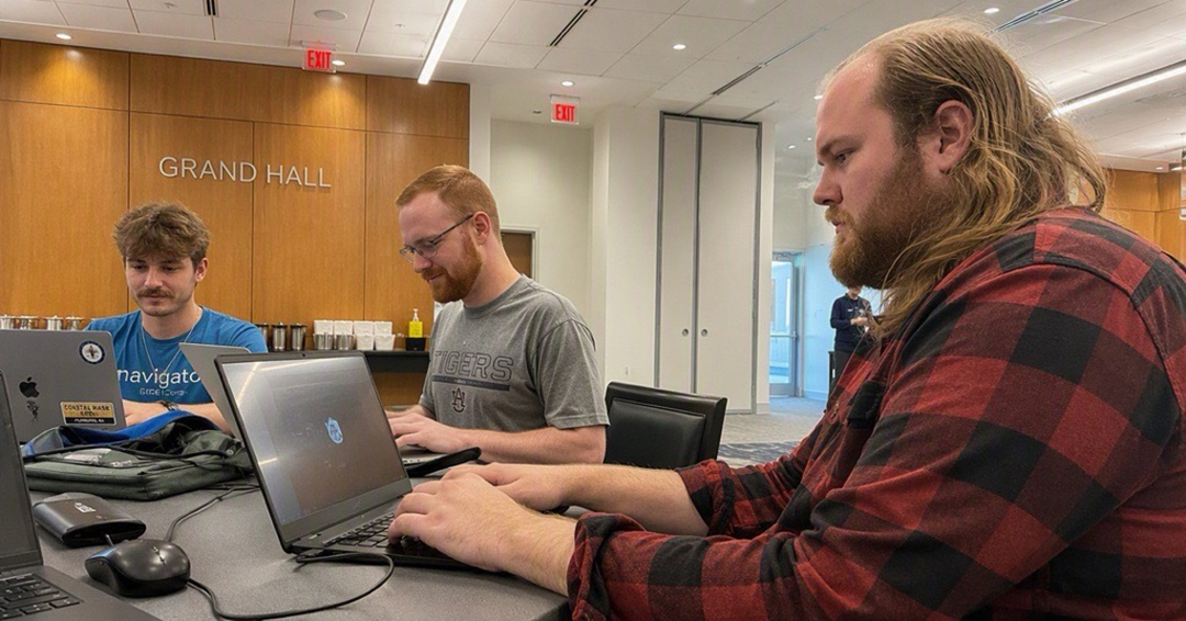 Auburn computer science students, from left, Nate Buck, Gabriel Basaraba and Gabriel Capron were among 67 students from three universities to participate at Cyber Fire Puzzles, held Aug. 21-23 at the Brown-Kopel Center..