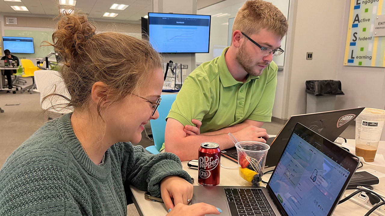 Computer science students Vicki McLendon and Kyle Ackerman enjoyed learning new software tools that trace the steps of cyber attackers.