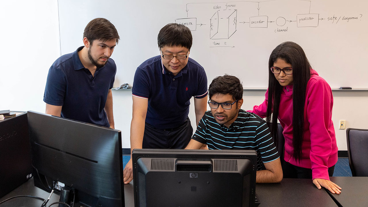 Professor Yin Sun with graduate students, from left, Thomas Orrison, Md Kamran Chowdhury Shisher, and Tasmeen Zaman Ornee.