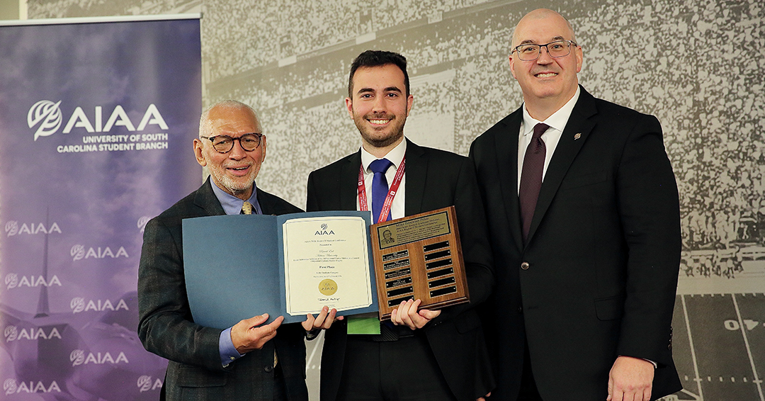 Patrick Eid receives the First Place Award and Mike Freeman Prize in the graduate division at the AIAA Region II Student Conference. From left are retired Maj. Gen. Charles F. Bolden Jr., Eid and Kurt Polzin.