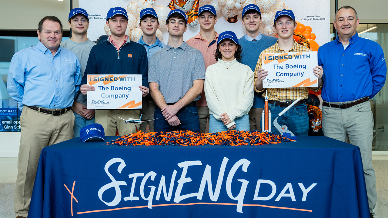  Group photo of Auburn Engineering students holding “I signed with The Boeing Company” signs during SignENG Day.