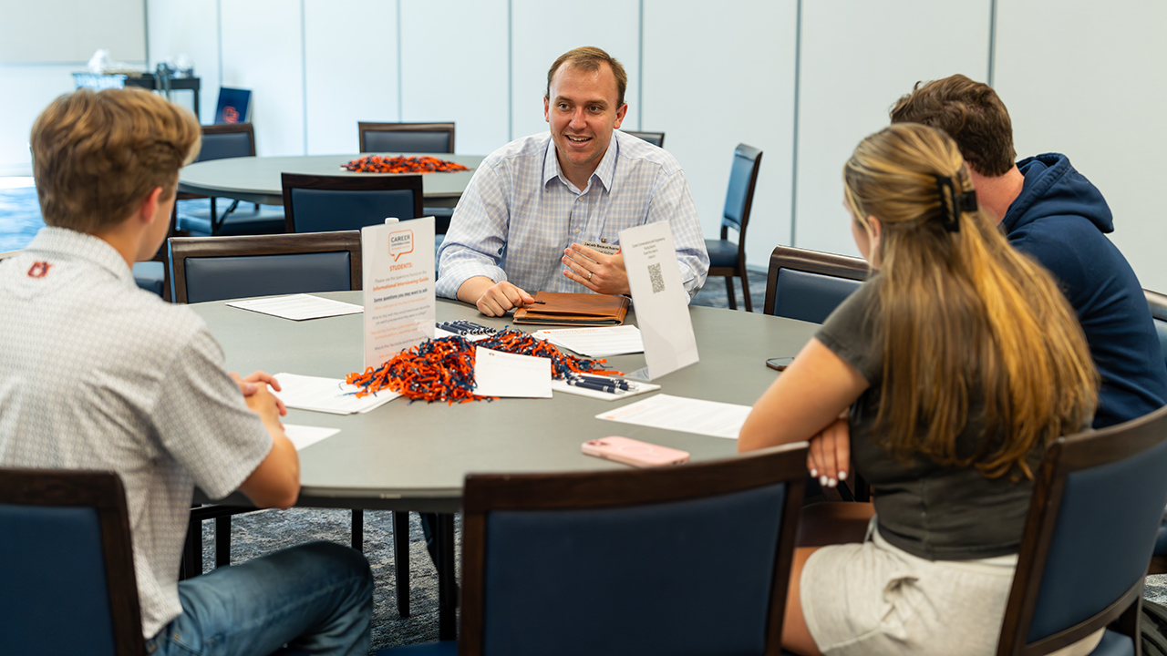  Industry representative sitting at a round table talking with Auburn Engineering students during a Career Conversations event. 