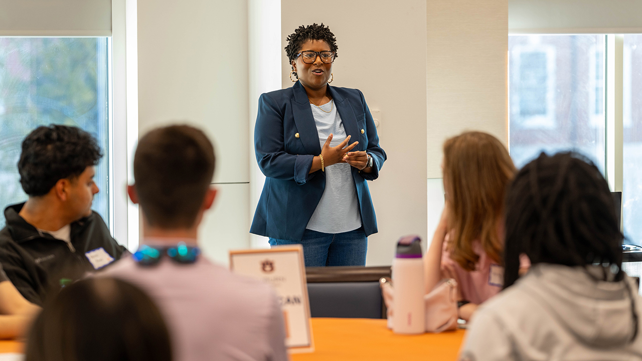 woman speaks to group of students