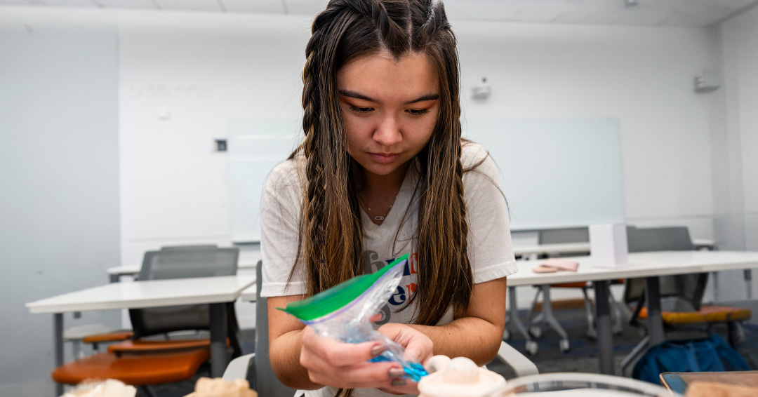 Brenna McAlister, a freshman in chemical engineering, works on a pottery project during an Auburn engineering course focused on fluid dynamics and design