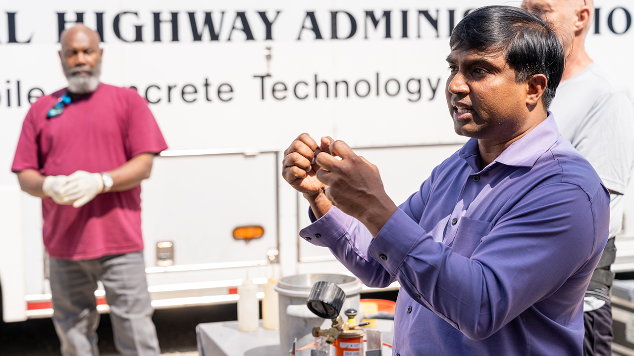 man in purple shirts talks with his hands