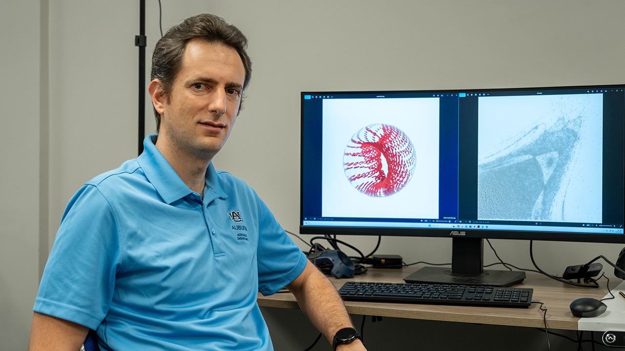 Davide Guzzetti, aerospace engineering associate professor, reviews orbital visualization outputs on his computer as part of a project focused on cislunar space dynamics.