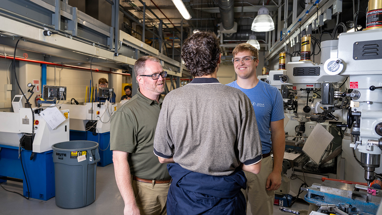 Jordan Roberts talks to two students in the DML Lab.