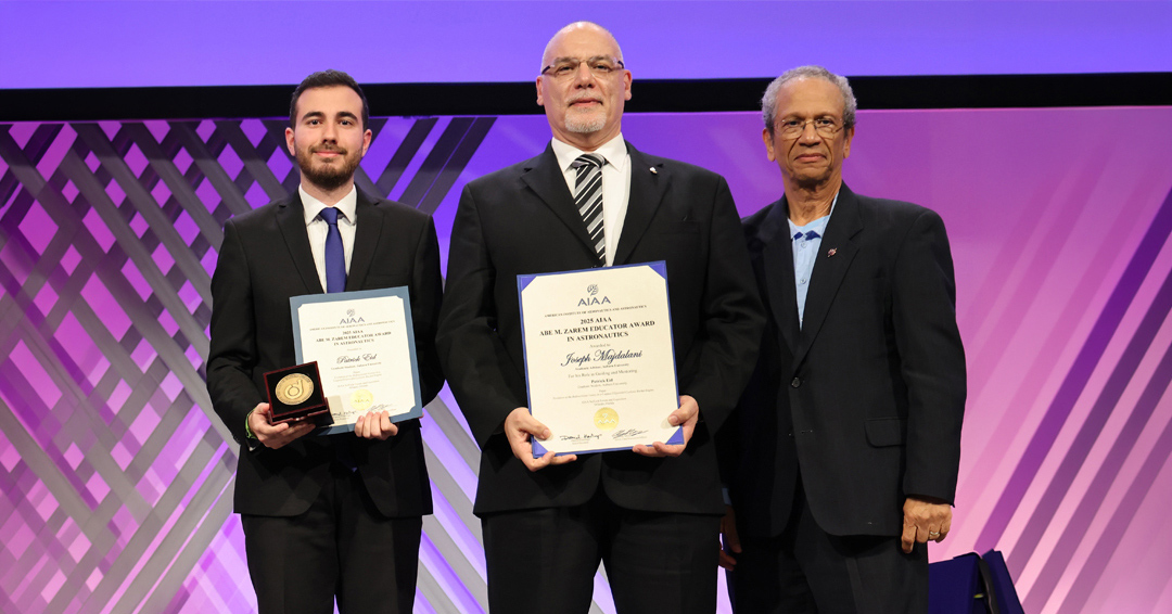 Joseph Majdalani (center) receives the AIAA Abe Zarem Educator Award alongside Patrick Eid (left) and AIAA President Daniel Hastings (right) at SciTech 2026.