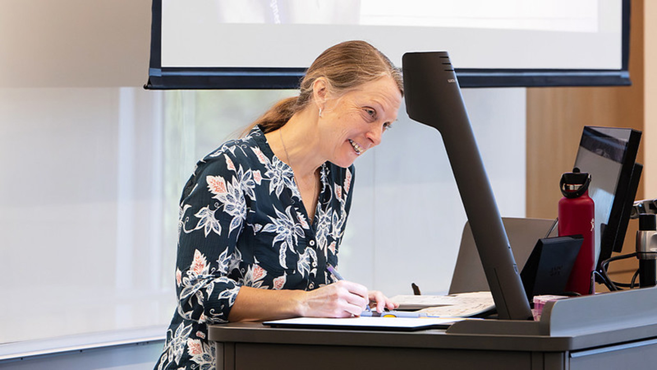 woman teaching in the front of a class