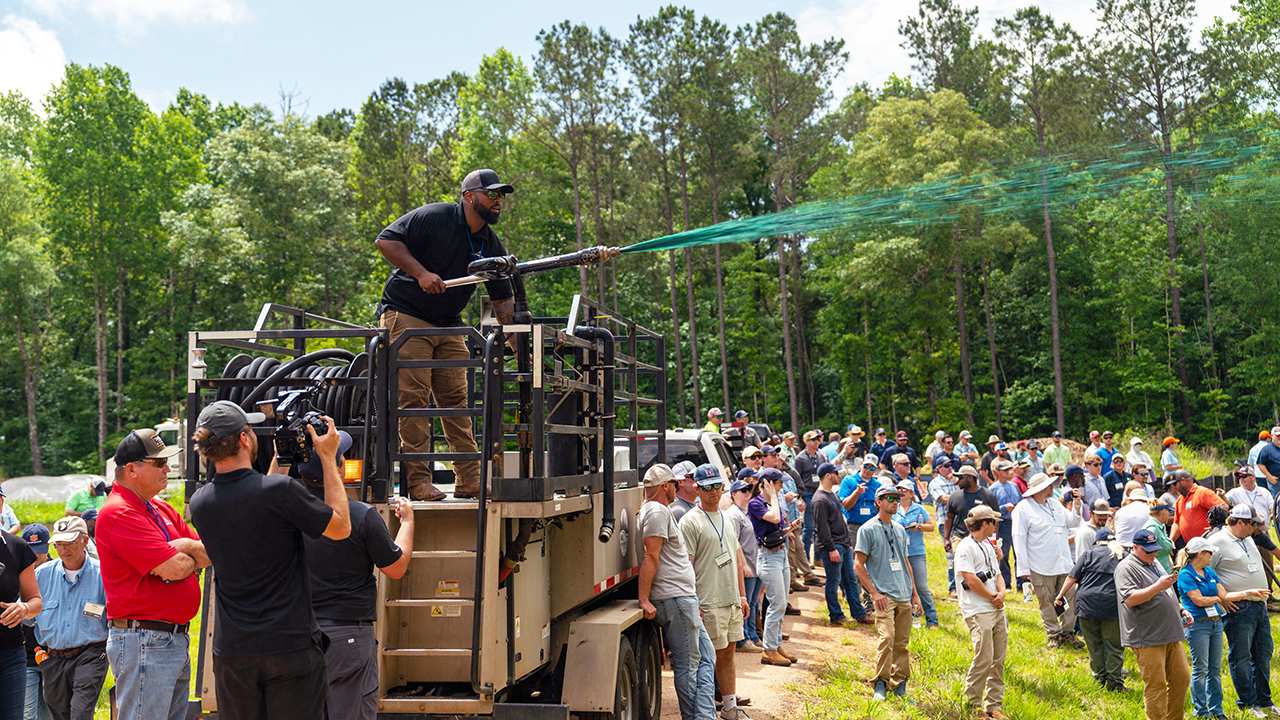 A participant at Auburn University - Stormwater Research Facility’s Stormwater Week sprays chemicals during a demonstration.