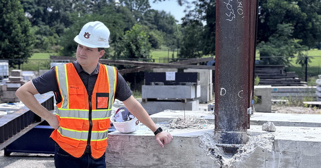 Murilo Tarozzo, a doctoral student in geotechnical engineering, stands beside an experimental pile bent specimen at Auburn University’s Advanced Structural Engineering Laboratory.