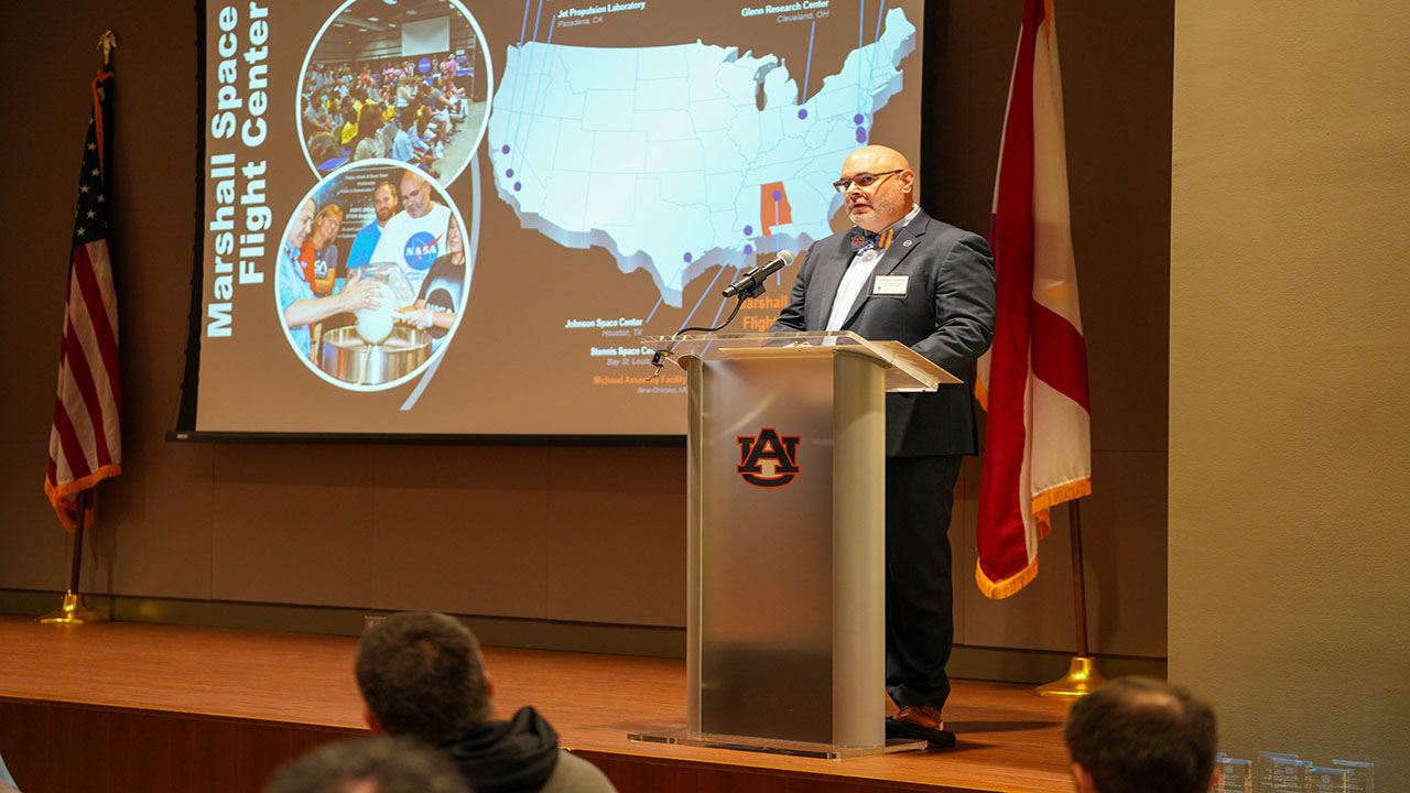 Joseph Pelfrey stands at the podium to deliver his keynote address.
