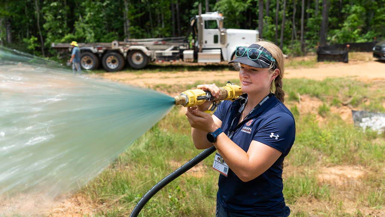 a woman sprays a hose