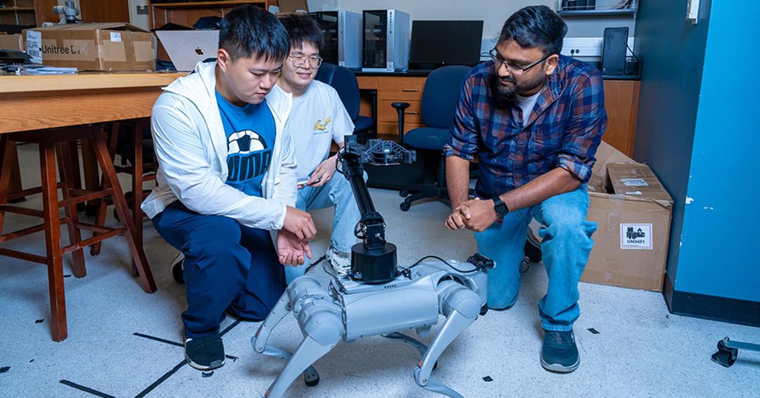 Associate Professor Sathya Aakur, right, with graduate students Joe Lin and Zhou Chen, is developing artificial intelligence methods that help intelligent embodied agents, aka robots, understand what objects can do, not just what they are.