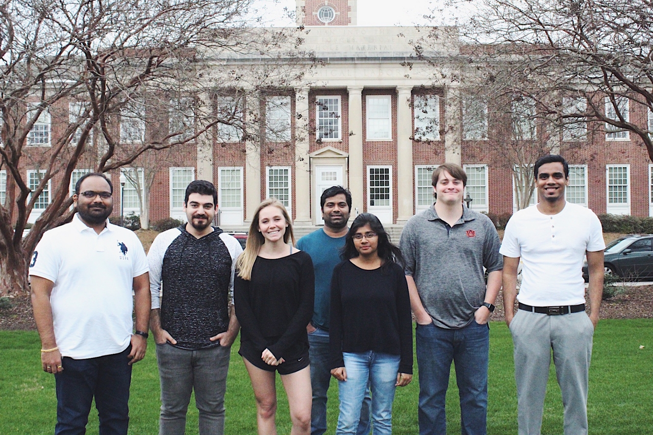 its a group picture of students in front of a building 