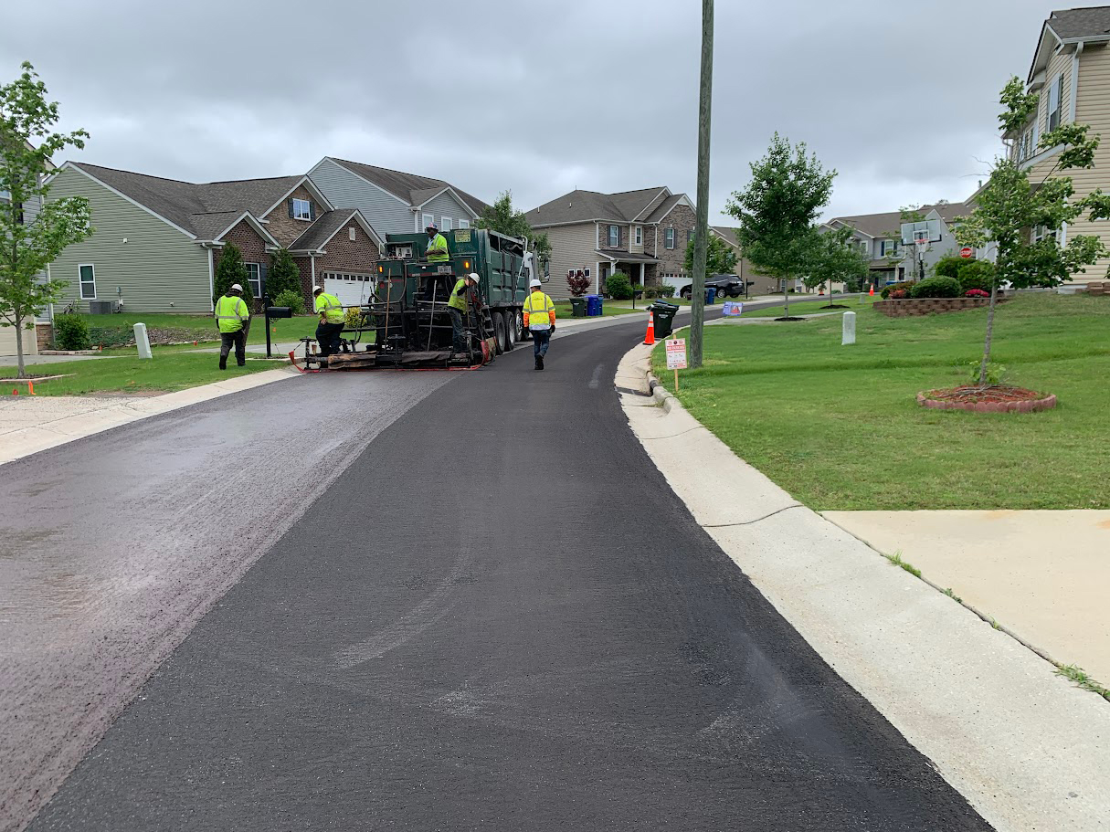 A crew applies micro surfacing on residential street