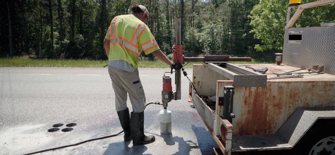 Steamroller passing over freshly paved surface