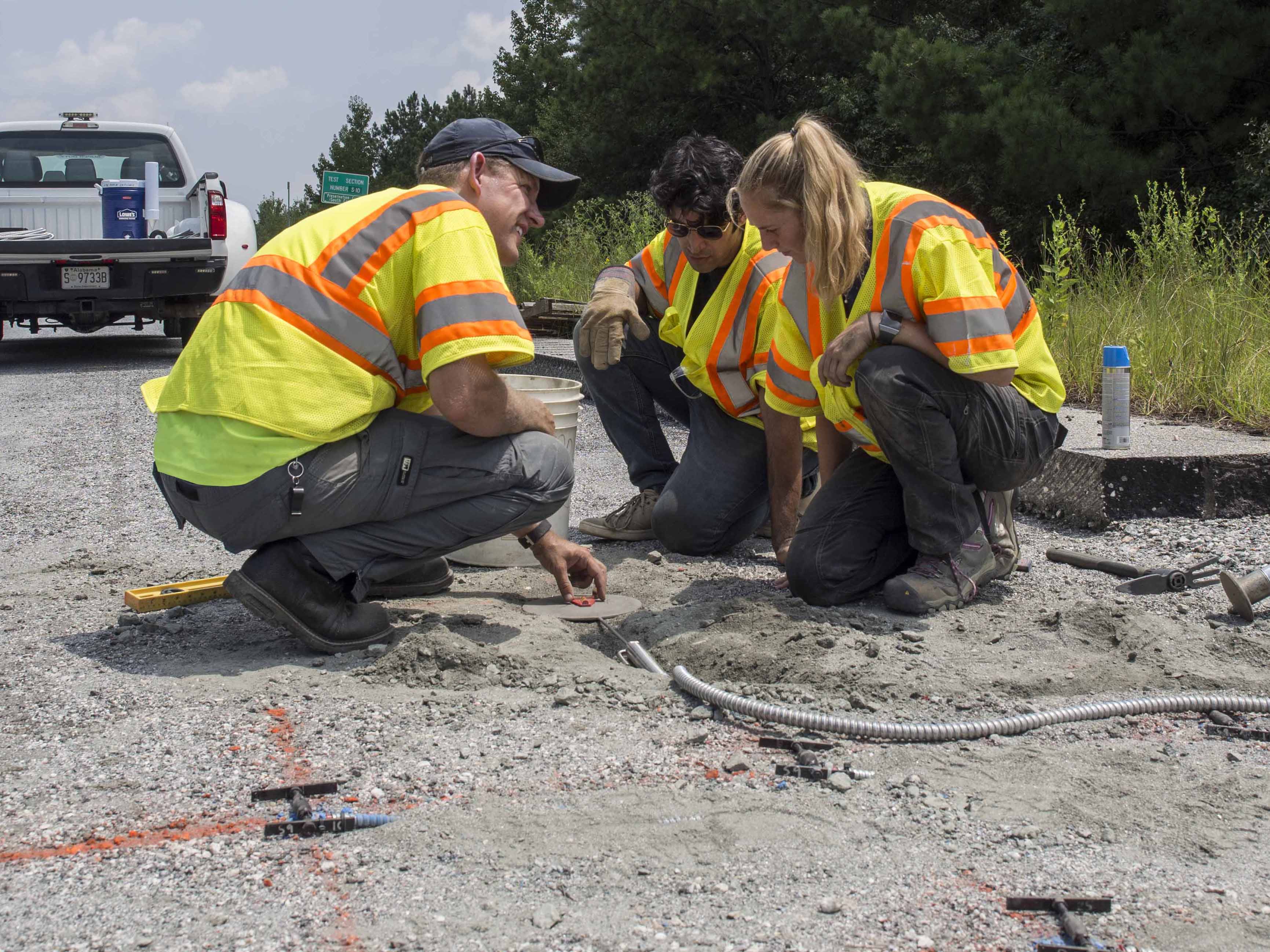 David Timm, Civil Engineering Professor at Auburn University, works with graduate students Mostafa Nakhaei and Caroline Taylor to place instrumentation in Section S9.