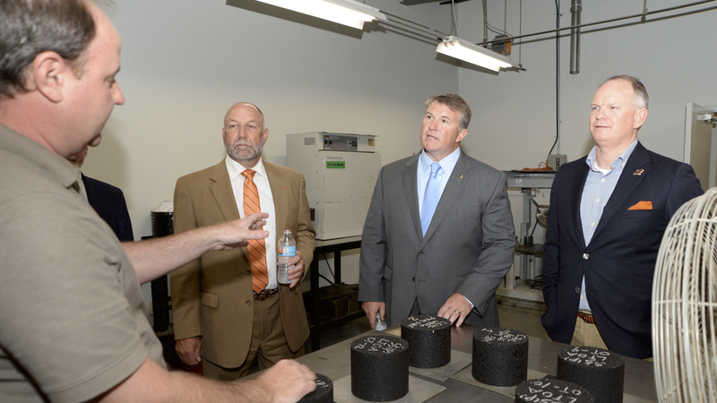 Auburn University President Steven Leath, left, Rep. Joe Lovvorn and Sen. Tom Whatley took a tour of NCAT’s research facilities led by NCAT board member Mel Monk and lab manager Jason Moore.