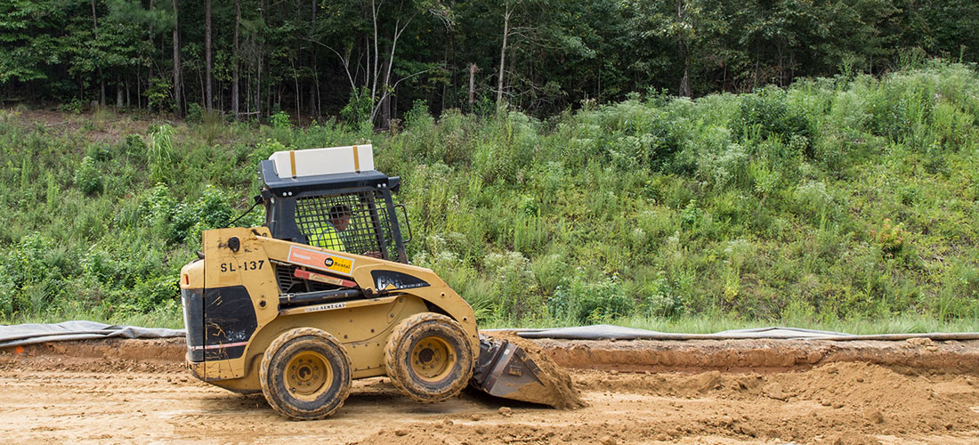 Steamroller passing over freshly paved surface