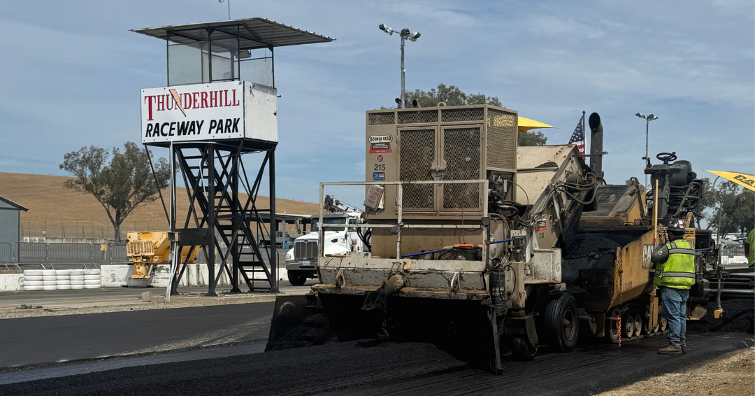 Asphalt paving crew places a new racing surface beside the Thunderhill Raceway Park tower.