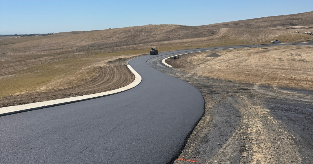 Newly paved asphalt racing surface curves through the rolling terrain at Thunderhill Raceway Park.